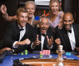 Happy, well-dressed gamblers winning at the roulette table