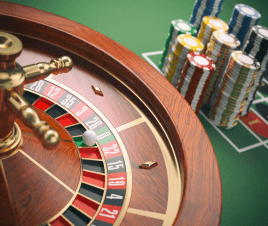 A roulette wheel and stacks of casino chips